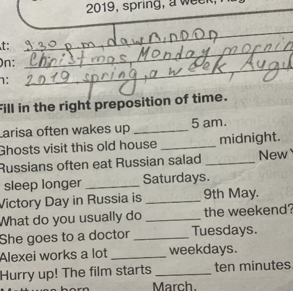 Fill in the right preposition of time. Larisa often wakes up 5 am.
