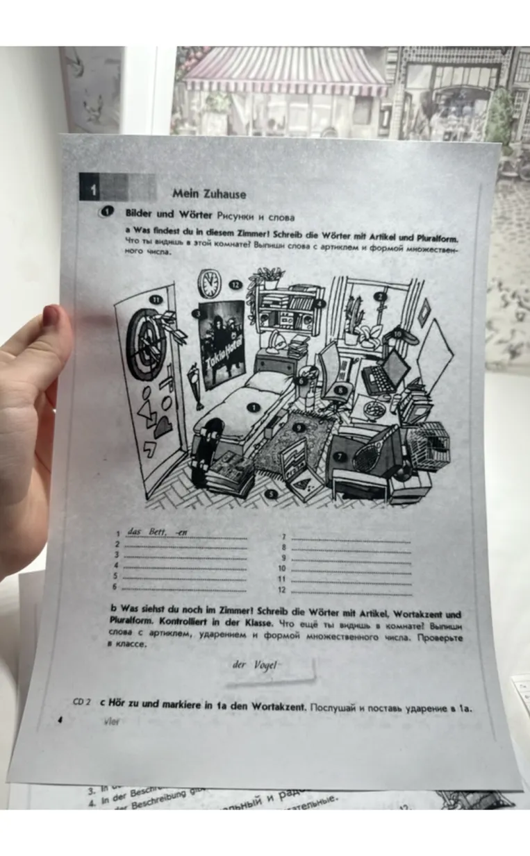 Was findest du in diesem Zimmer? Schreib die Wörter mit Artikel und Pluralform.