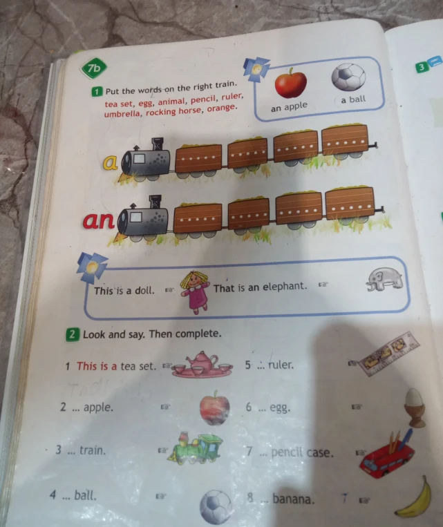 Put the words on the right train: tea set, egg, animal, pencil, ruler, umbrella, rocking horse, orange. Look and say. Then complete.