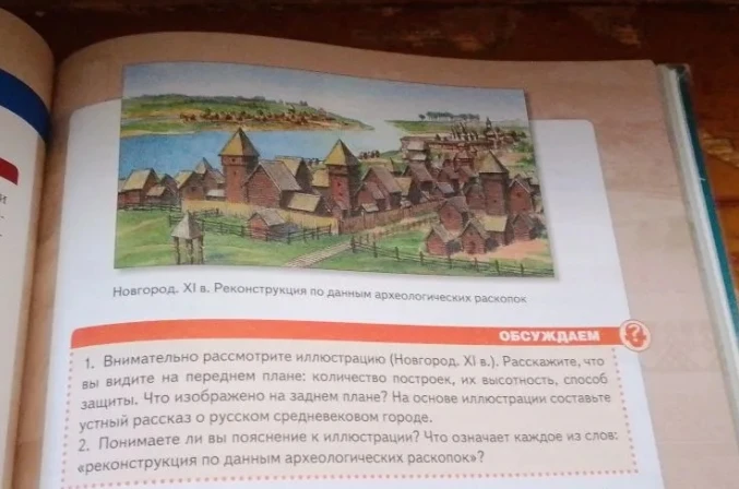 Внимательно рассмотрите иллюстрацию (Новгород. XI в.). Расскажите, что вы видите на переднем плане: количество построек, их высотность, способ защиты.