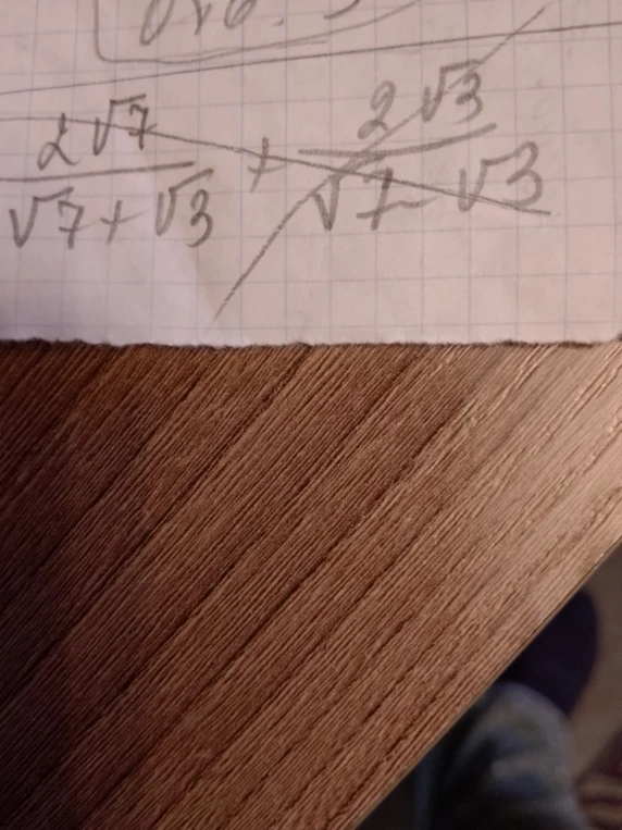 Допущение: выражение записано как \frac{2\sqrt{7}}{\sqrt{7} + \sqrt{3}} + \frac{2\sqrt{3}}{\sqrt{7} - \sqrt{3}}.